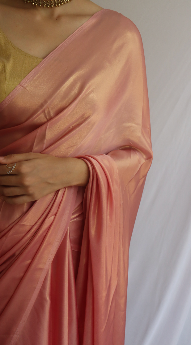 Detailed view of the shimmering fabric of the Rosy Pink Saree, highlighting its texture and quality.