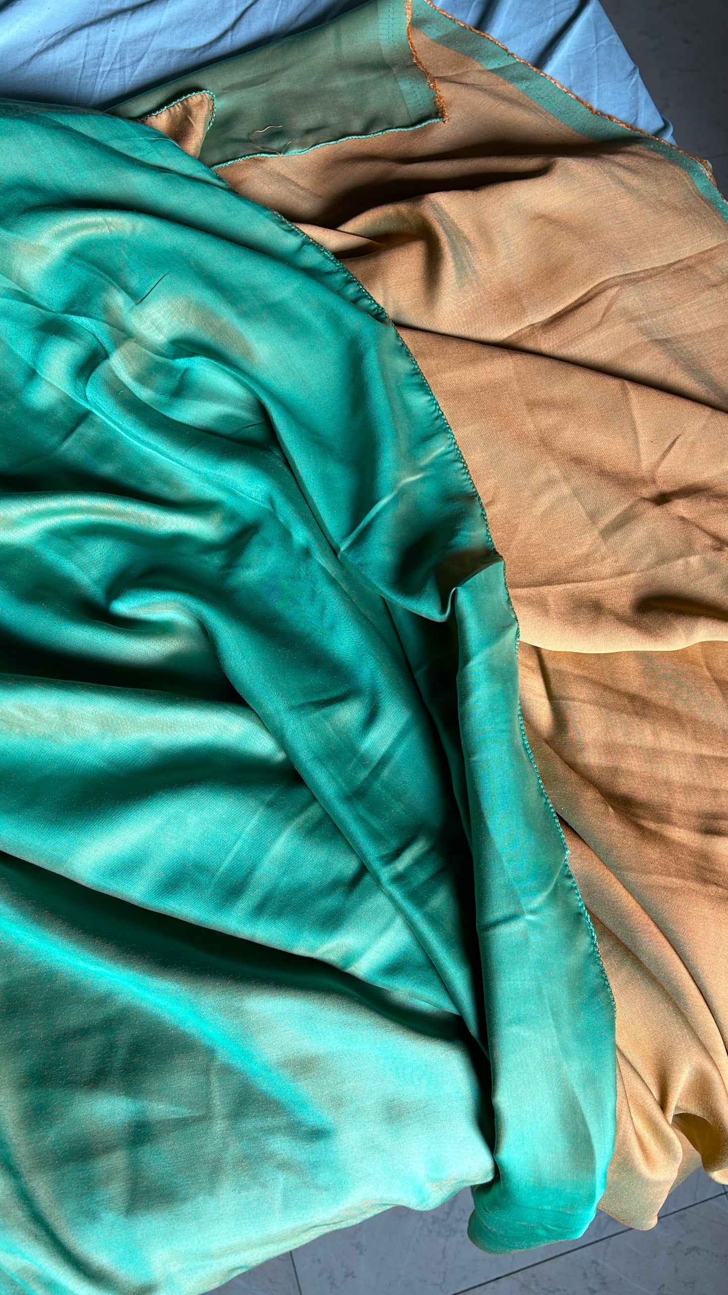 Detailed view of the soft fabric of the Teal Green and Mango Yellow Reversible Saree, highlighting its texture and quality.