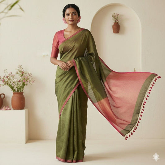 Model wearing dark green and pink linen tissue saree for festive occasions