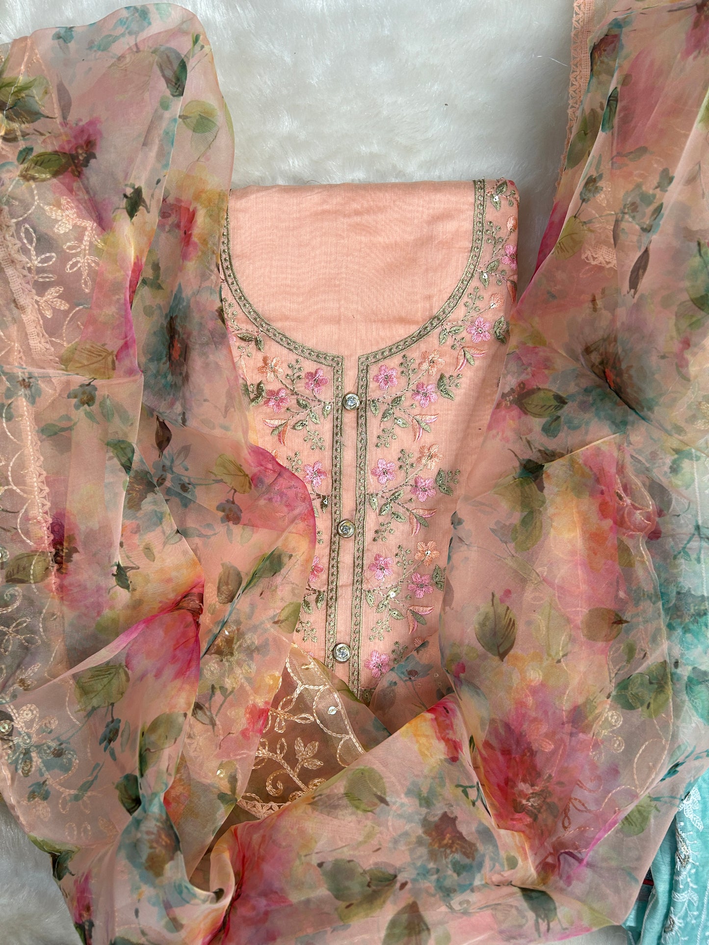 Elegant Fully Worked Unique Organza Unstitched Suit displayed, highlighting its intricate embroidery and luxurious fabric.