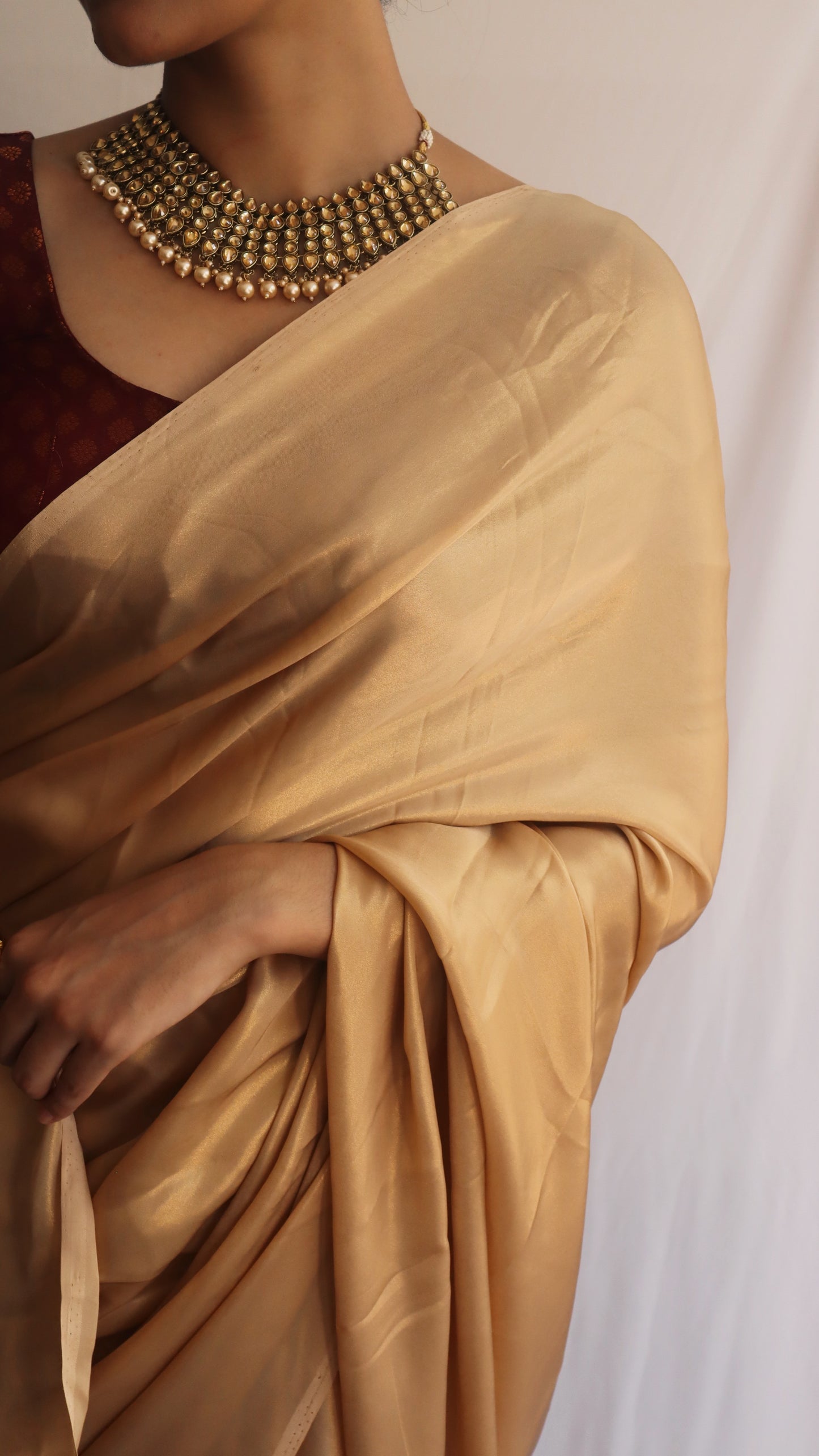 Stunning Gold Shimmer Saree displayed elegantly, showcasing its luxurious fabric and beautiful shimmer.