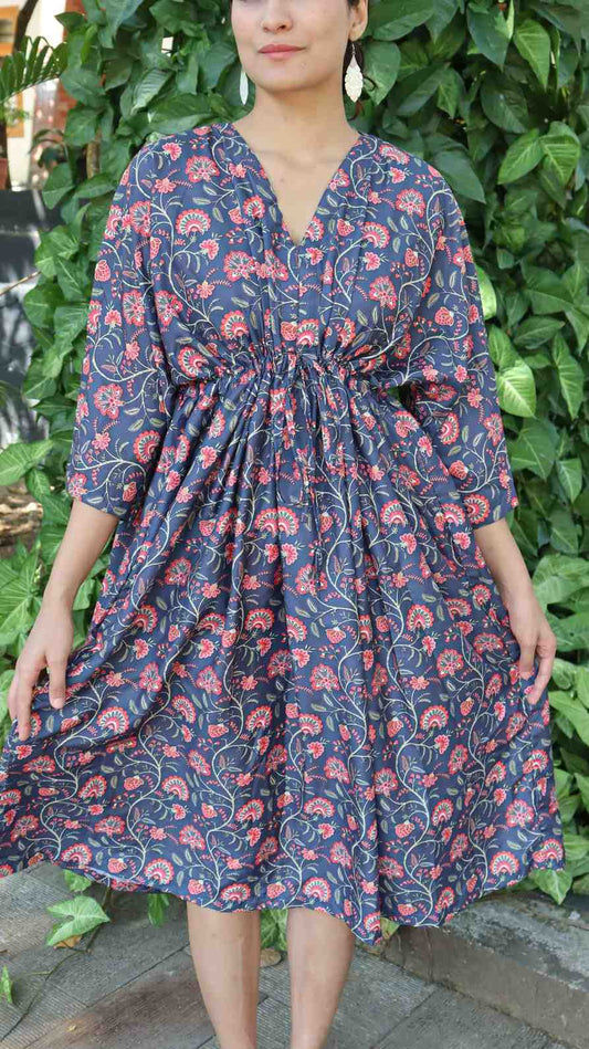 Close-up of indigo floral print rayon cotton fabric showing soft texture, stitching and lightweight finish.