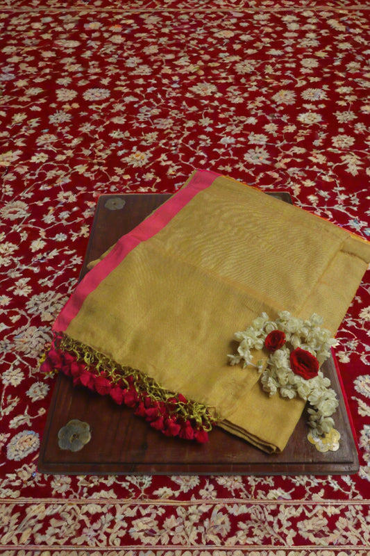 The Lime Pink Cotton Tissue Saree elegantly draped on a display, showcasing its stunning color combination