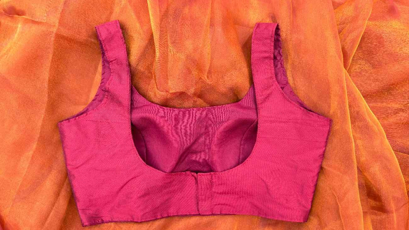 Back view of the Maroon Grace Blouse by Label Anaira showing the smooth maroon finish and sleeveless design. The blouse offers a minimal, versatile style and comes with additional short sleeves with lining for customizable wea