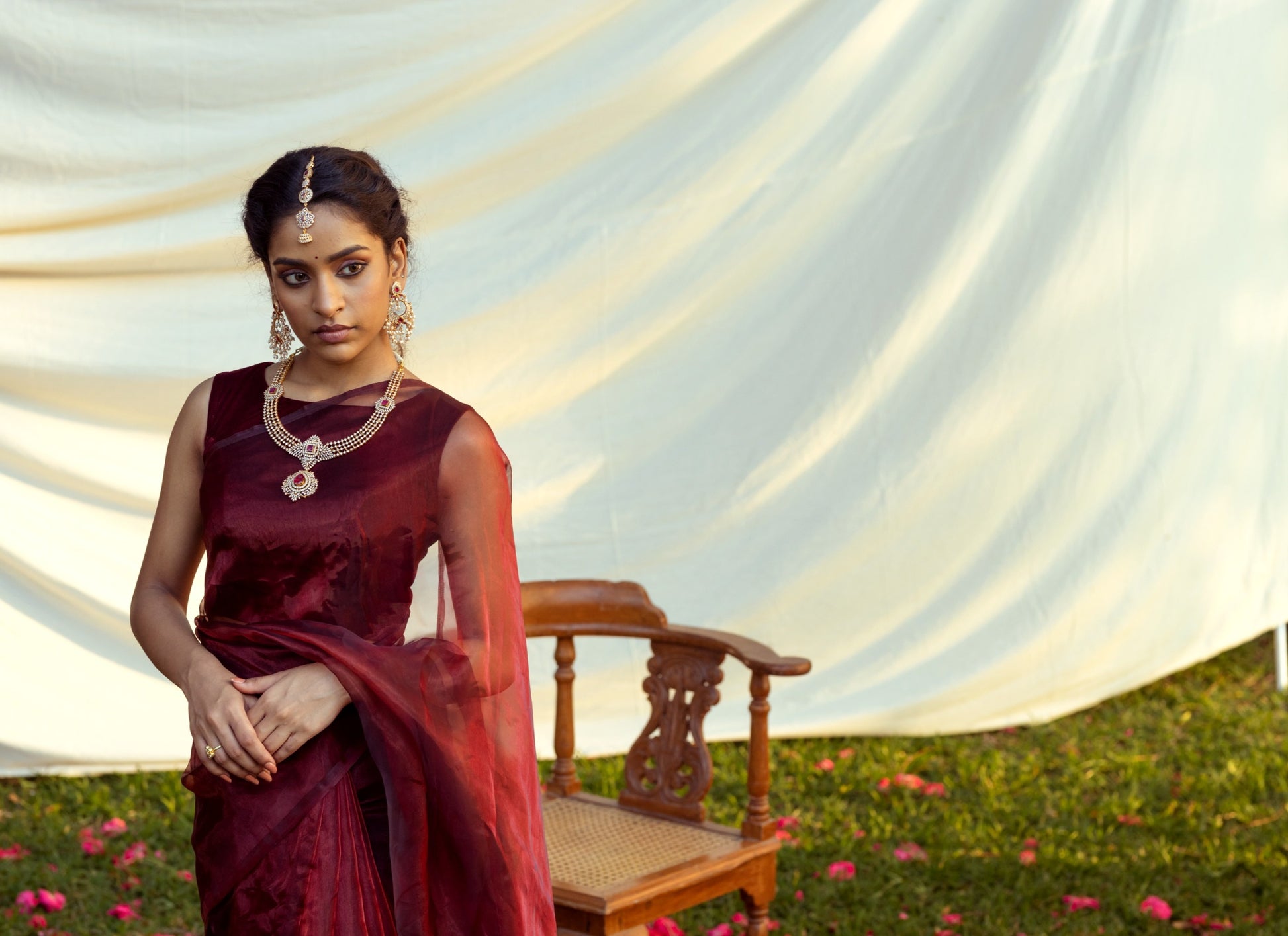 A model elegantly draped in the Blood Red Semi Organza Saree, showcasing its beautiful fit and vibrant color