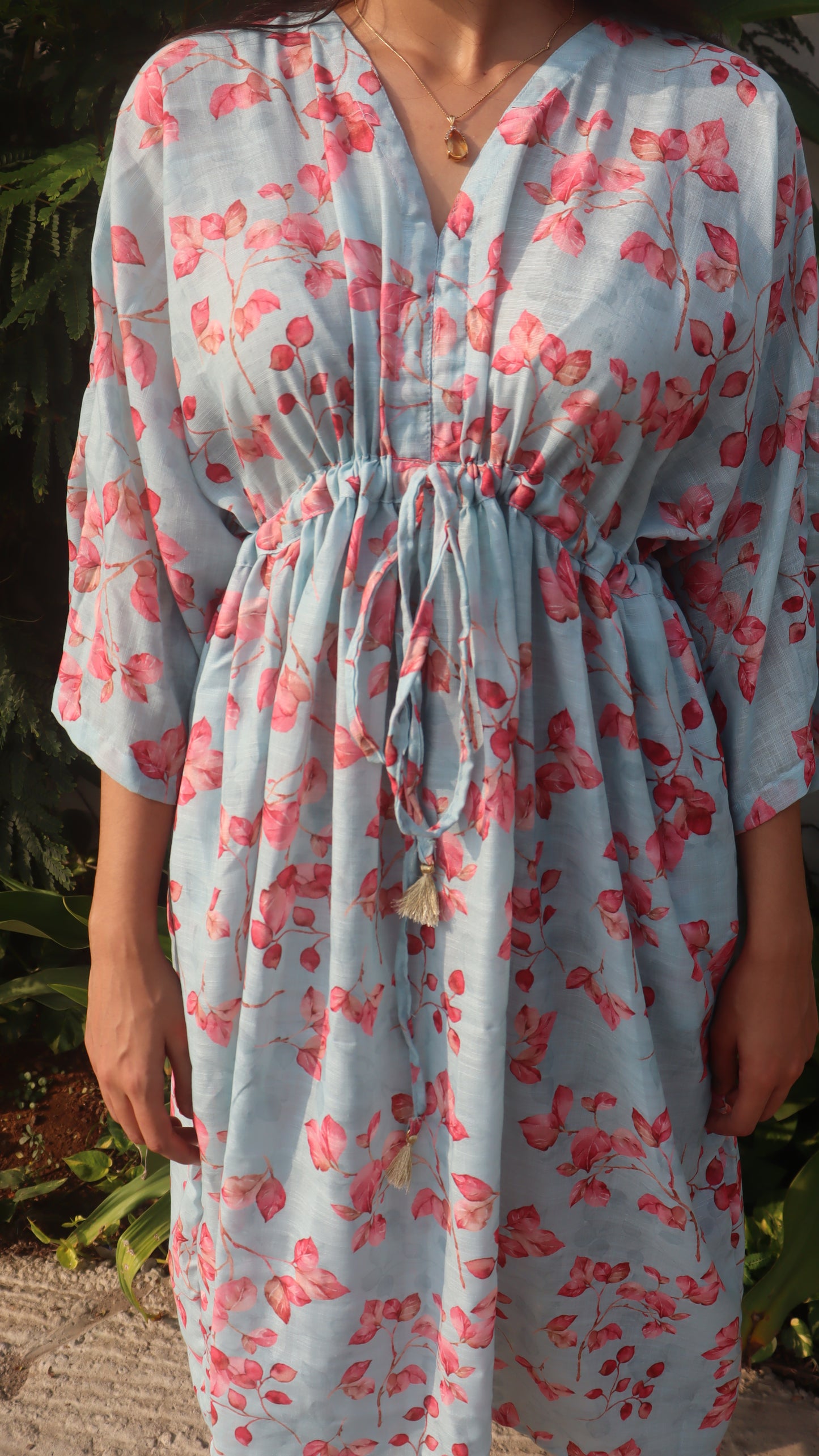 A model showcasing the Bougenville Free Size Dress from the front, emphasizing its flattering fit and beautiful floral design