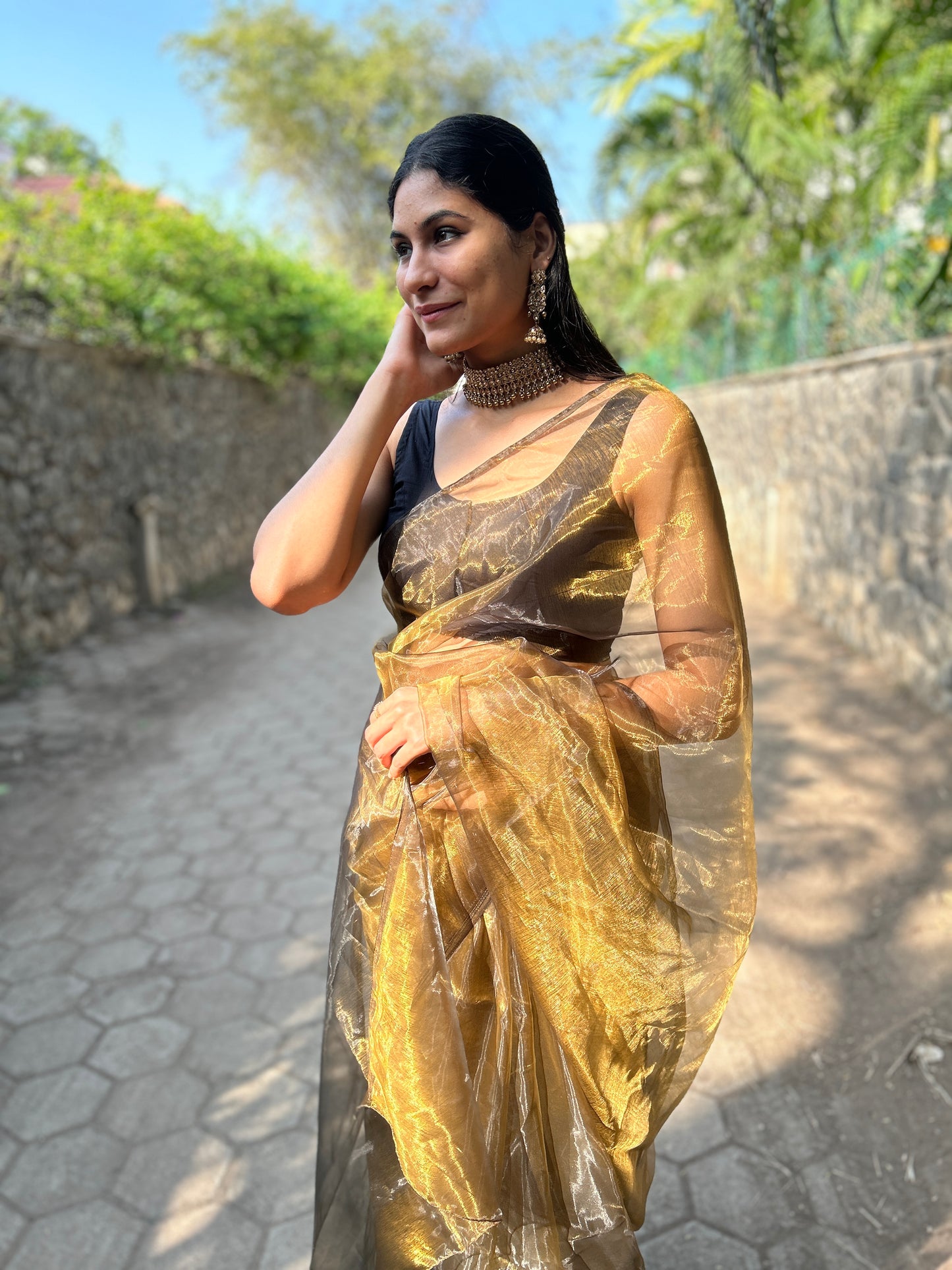 Side view of a model wearing the Glimmering Shadows saree, highlighting its flowing silhouette and luxurious design.