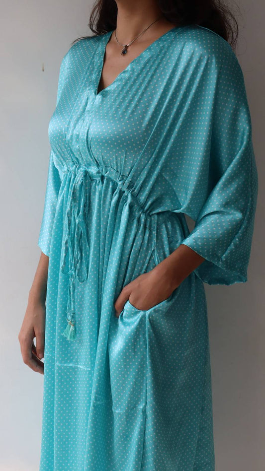 Side pocket detail of light blue satin polka dot dress