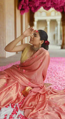 woman wearing a pink shimmer beautiful saree for a wedd