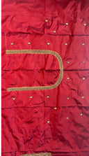 Red fabric with gold embroidery and embellishments