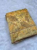 Floral-patterned marigold aurielle fabric on a white background