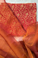 Close-up of Banaras Ki Queen Beepatterned fabric with sheer orange fabric in the foreground.