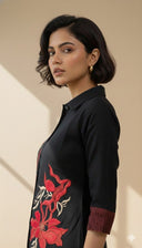 Side view of Black Iris co-ord set highlighting red floral embroidery