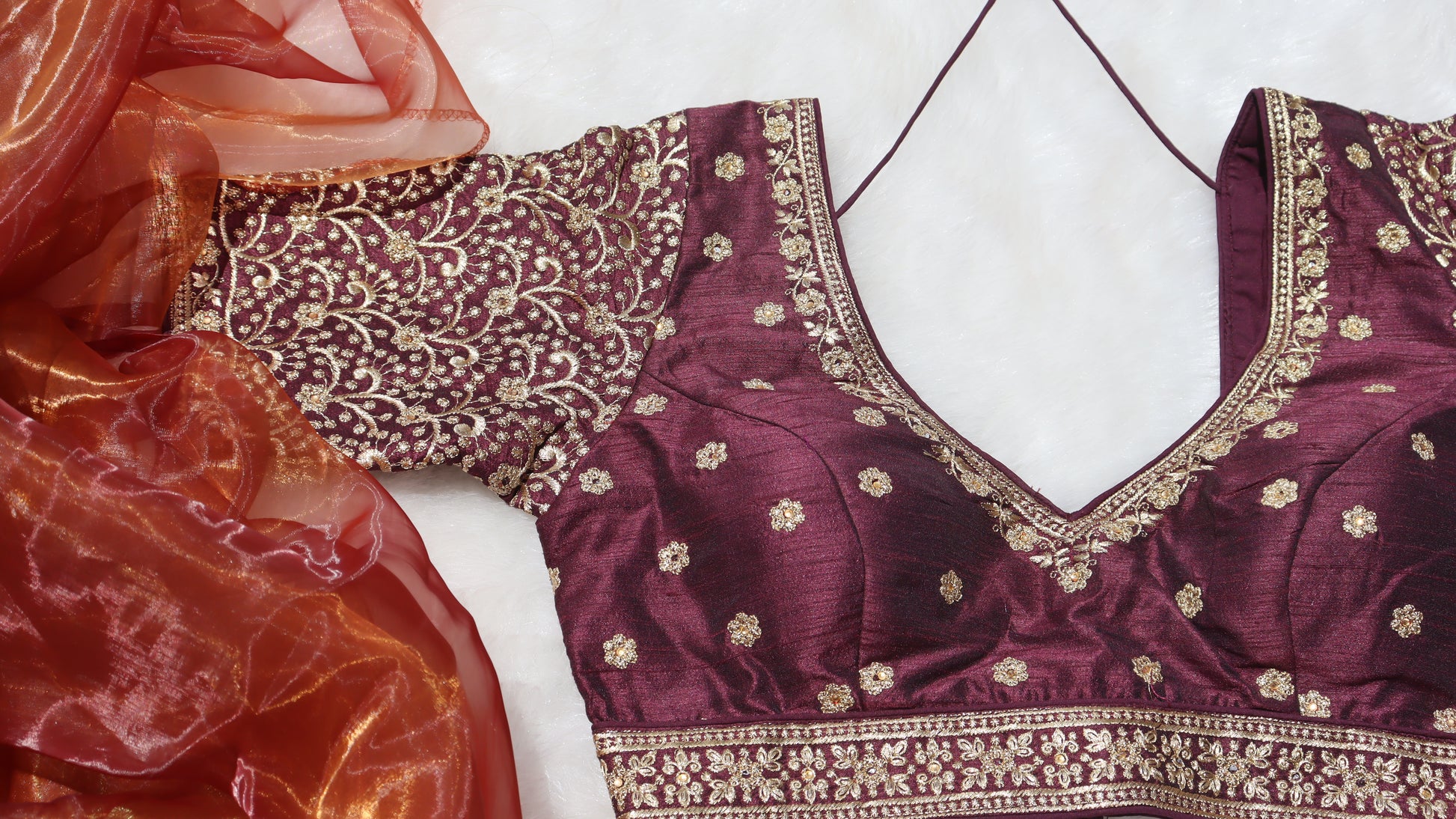 Brown blouse with gold thread work paired with honey organza saree