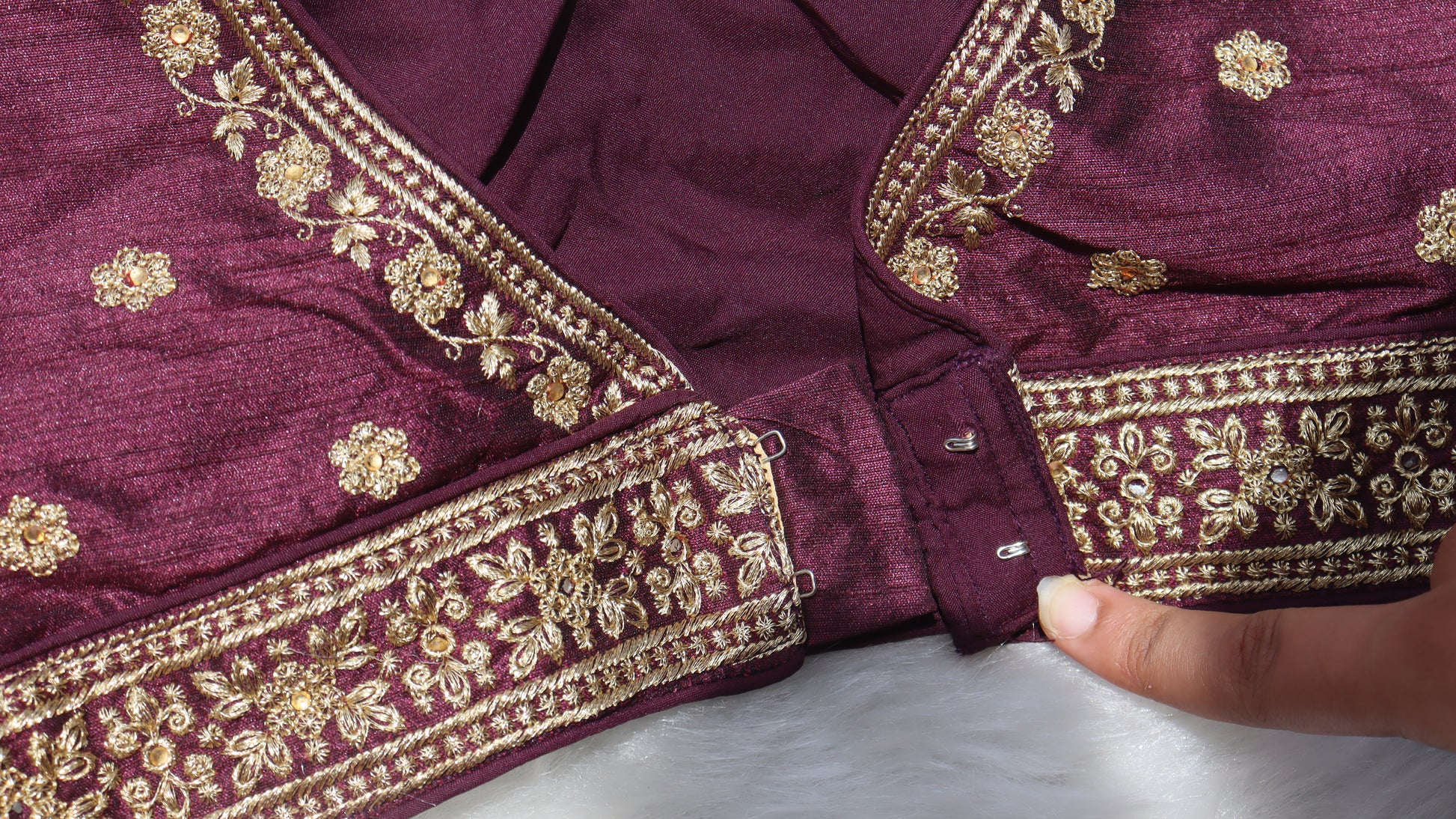 Image showing the clasp of a traditional brown blouse
