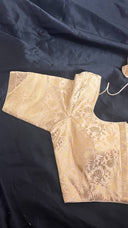 Champagne Glow Blouse sleeve on a dark fabric background