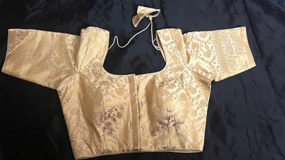 The Champagne Glow Blouse beautifully displayed, showcasing its rich fabric and elegant design, perfect for pairing with sarees or skirts.