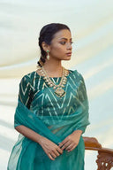 model in Teal Organza Saree with a white background