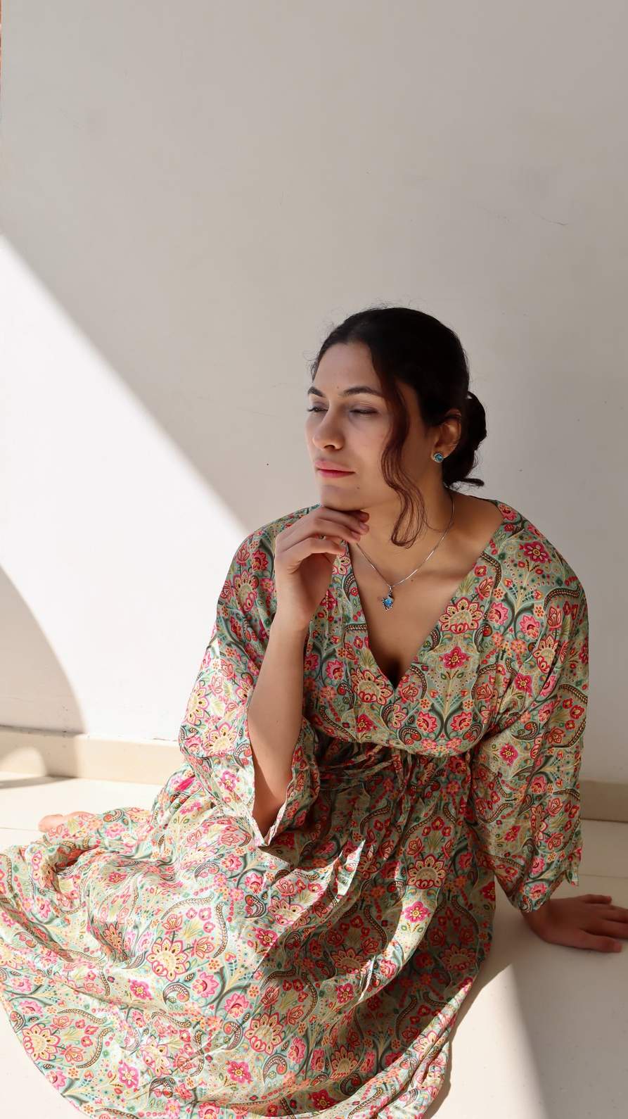 Lifestyle image of the Meadow Paisley Free Size Crepe Pocket Dress in natural light showing its airy fall, adjustable waist tie, and comfortable plus-size friendly fit.