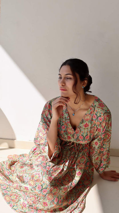 Lifestyle image of the Meadow Paisley Free Size Crepe Pocket Dress in natural light showing its airy fall, adjustable waist tie, and comfortable plus-size friendly fit.