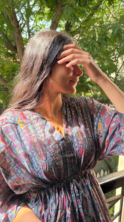 An Artful Attire Free Size Dress elegantly draped on a display, showcasing its beautiful colors and intricate design