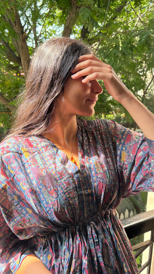 An Artful Attire Free Size Dress elegantly draped on a display, showcasing its beautiful colors and intricate design