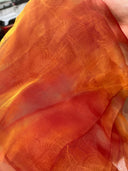 Close-up of Glow In the Sun Honey Organza Blouse Material held by a hand.