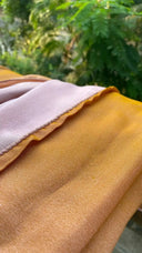 Close-up of Gold plus cream with a blurred green outdoor background