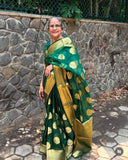 Grandmother in beautiful green banarasi organza saree with stone wall background