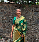 Grandmom, elderly woman wearing organza material with banarasi work and gold zari, the saree is shining under the sun making her look so beautiful.
