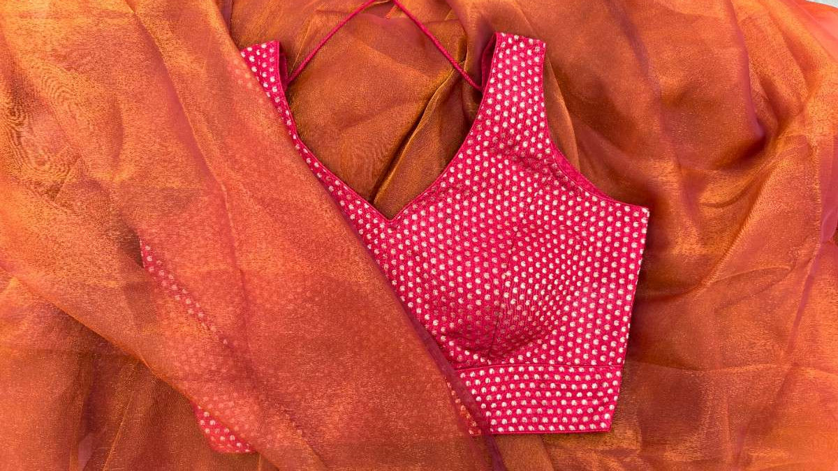 Styled look of Label Anaira’s Mango Bloom Red Blouse paired with a festive honry queen bee saree. Sleeveless design with gold mango (paisley) motifs and optional short sleeves offer elegance, comfort, and versatility for special occasions