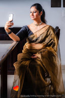 Women in Organza Saree sitting down taking a selfie
