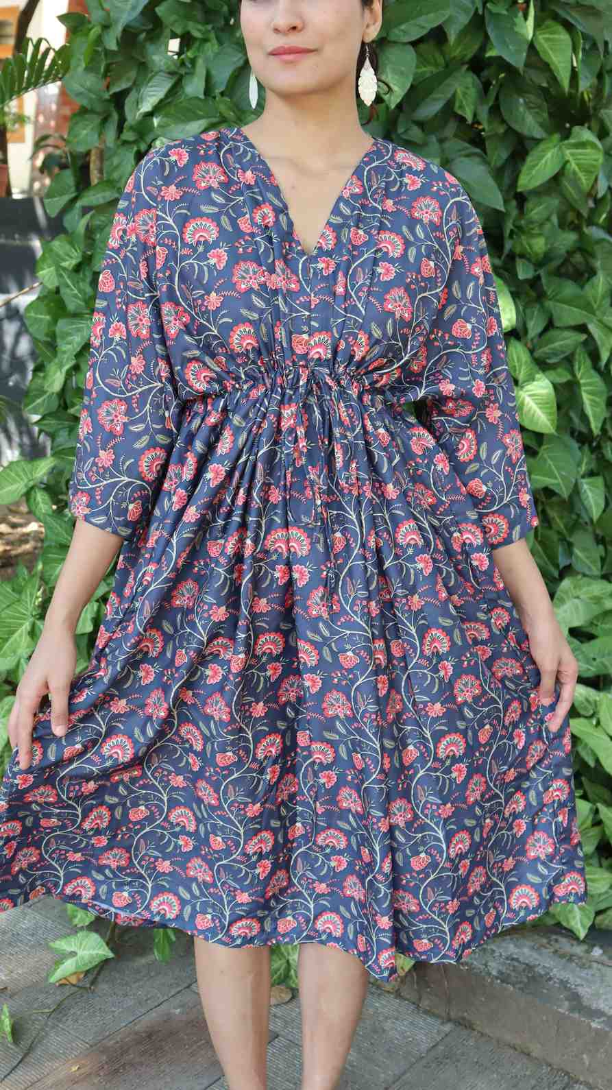 Close-up of indigo floral print rayon cotton fabric showing soft texture, stitching and lightweight finish.