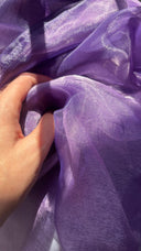 Close-up of a hand holding lavender fabric