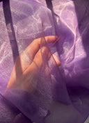 Hand against a purple fabric 
