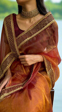 Woman wearing Luxury Empress Saree saree with intricate designs against a blurred natural background