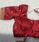 Zoomed in image of the thread embroidery in a red blouse