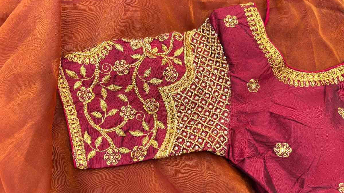 Close-up of the Noor-e-Zari Blouse sleeve showing intricate floral and paisley motifs in gold thread embroidery. The thick embellished cuff showcases traditional craftsmanship, ideal for wedding and festive ensembles.
