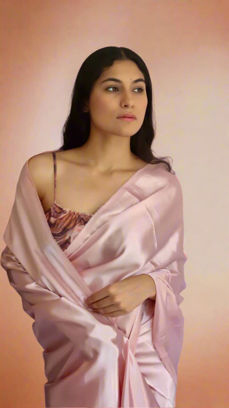 Woman wearing a blush pink satin saree