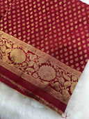 Red fabric with gold patterns on a white background