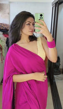 Woman taking a mirror selfie wearing pink satin saree