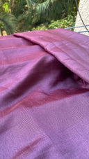 Close-up of Shades of Purple fabric with a blurred natural background