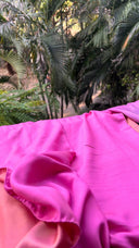 Close-up of Shades of Pink - Reversible Saree blurred greenery in the background