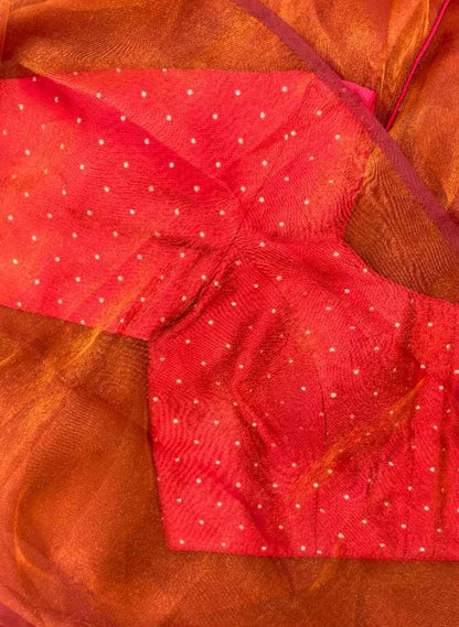 Styled look of the Sindoor Gold Polka Blouse paired with a festive saree. Sleeveless red blouse with dori tie-up back, shimmering gold polka embroidery, and rich texture creates a luxurious and celebratory ensemble for weddings, parties, and traditional events