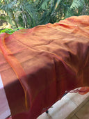 Honey fabric with a blurred background of green foliage