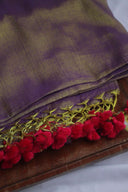 Close-up of Unique Shade of Purple Linen Tissue Saree fabric with purple and green pattern and red tassels on a white background