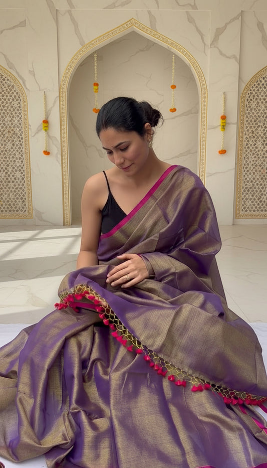 Woman wearing a purple saree very unique easy to drape on a festive background