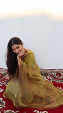 Drape view of A Secret in the Garden Olive Organza Saree by Label Anaira showcasing the flowing lightweight organza fabric and soft olive green tone.