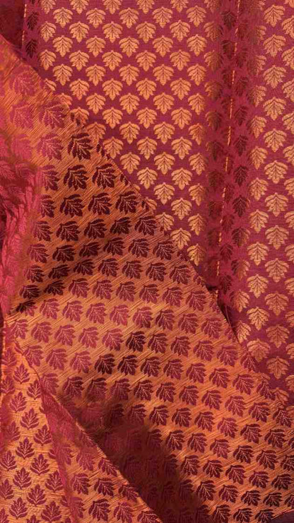 Close-up of a textured fabric with a leaf pattern on a red background