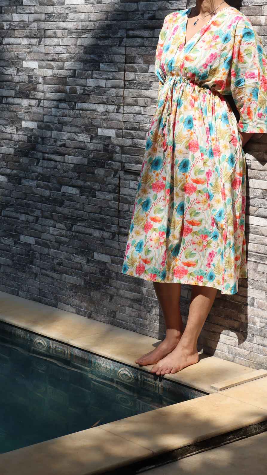 Side view of Blue and peach floral rayon free size dress with pockets for women